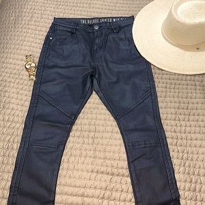 Black coated mid rise pants with zipper at legs